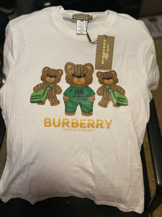 White Burberry t-shirt with teddy bear graphics and tags on a black background